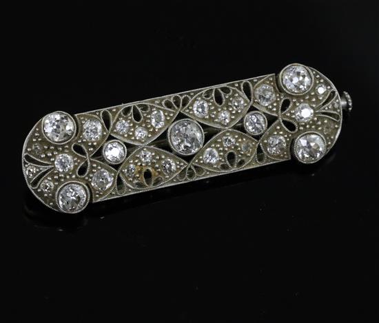 A Belle Epoque platinum? and millegrain set diamond pierced ovoid brooch, 43mm.